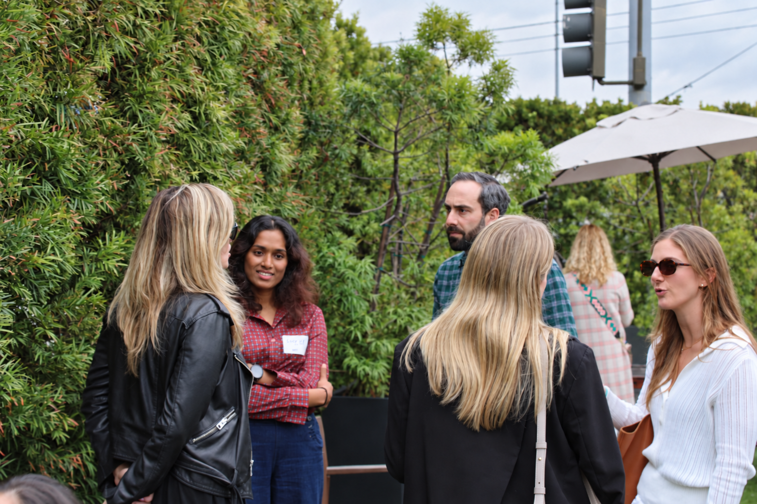 Attendees talking outdoors at an M13 Launchpad gathering in Los Angeles, September 2024